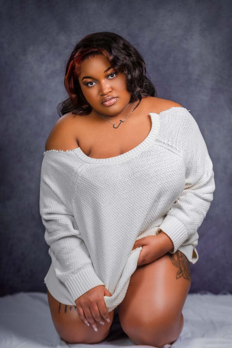 Beautiful black girl with long hair, sexy white t-shirt, kneeling.
