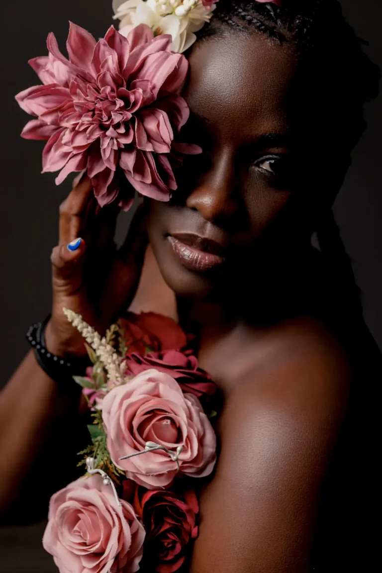 Balck female model with roses in her hair.