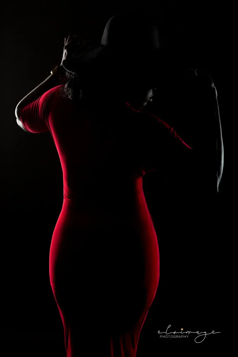 Balck female model in red dress.