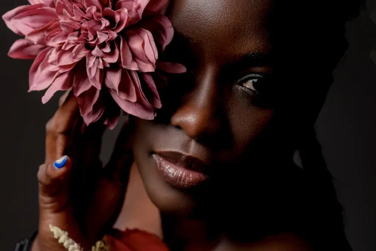 afro American female beauty portrait with pink rose.